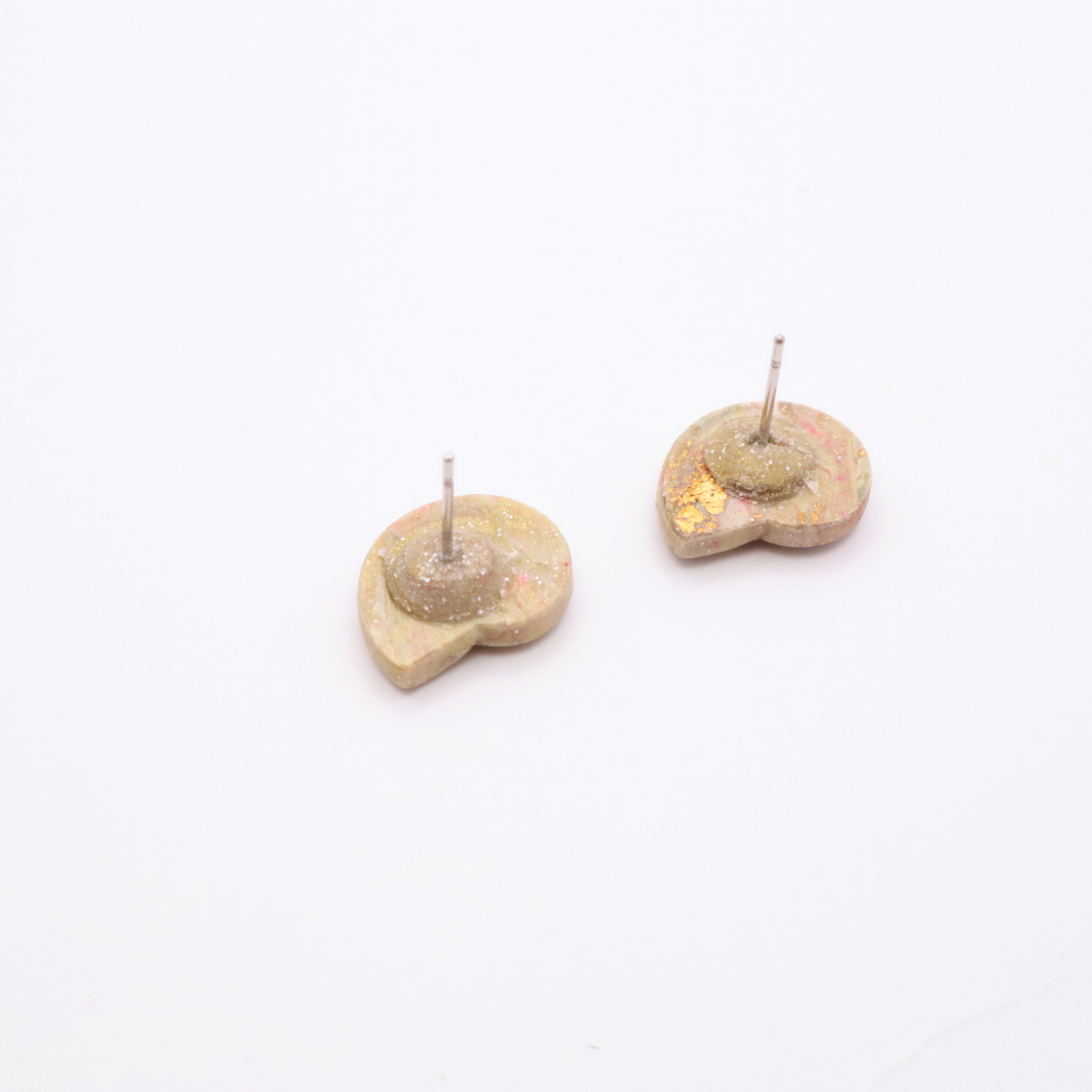 Back view of handmade resin shell stud earrings with stainless steel posts and glitter backing