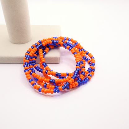 Set of six orange and blue and white seed bead stretch bracelets featuring random orange and blue seed beads on a white background