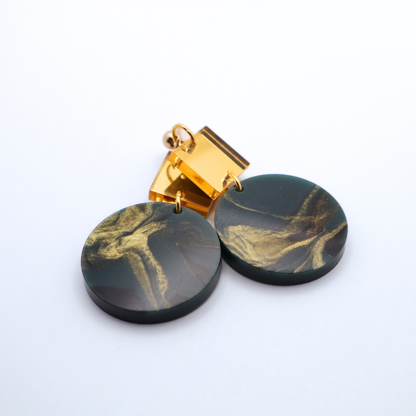 Marble-patterned green earrings with gold accents on a white background