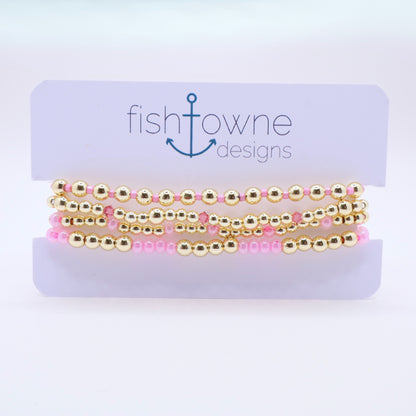 Handmade beaded bracelet set with pink glass beads and sparkling crystal details.