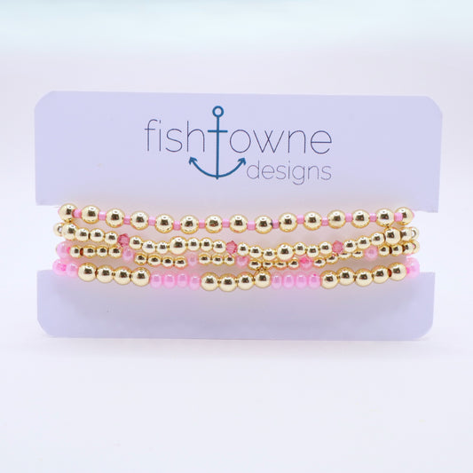 Handmade beaded bracelet set with pink glass beads and sparkling crystal details.