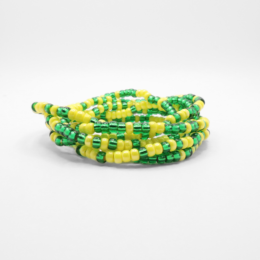Set of six green and yellow seed bead stretch bracelets featuring random green and yellow seed beads on a white background