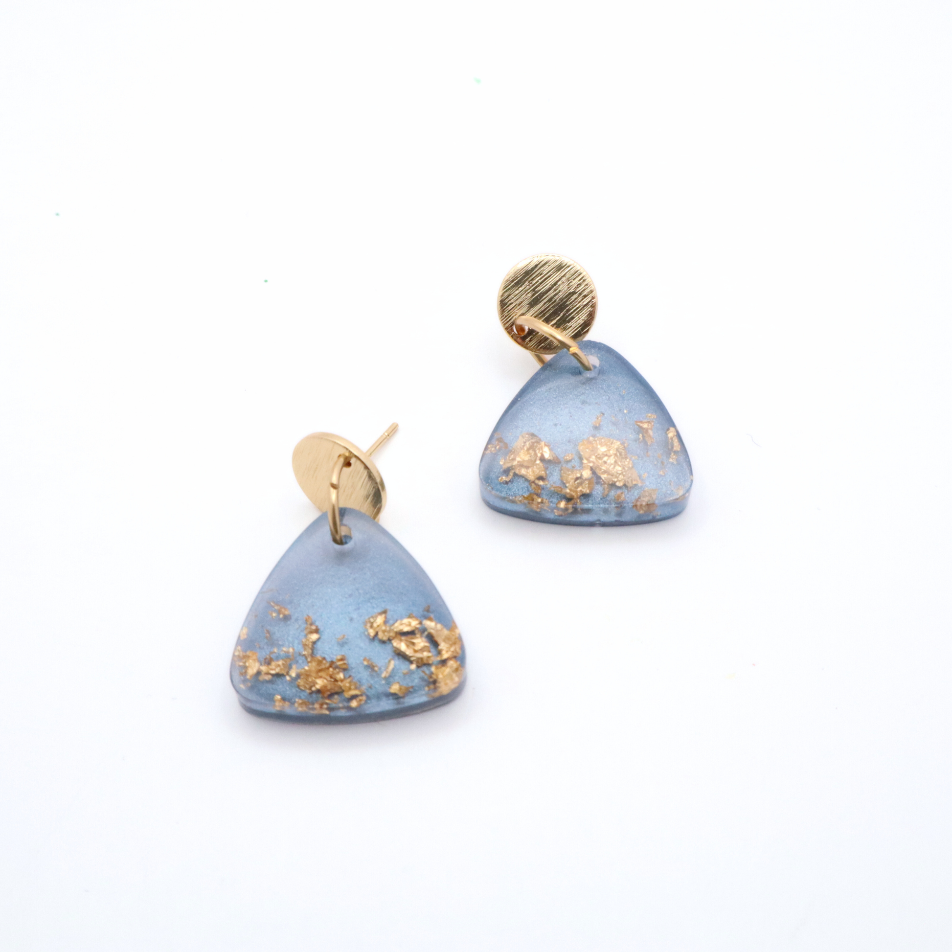 Blue earrings with gold accents on a white background