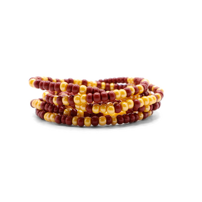 Set of six burgundy and gold seed bead stretch bracelets featuring random burgundy and gold seed beads on a white background