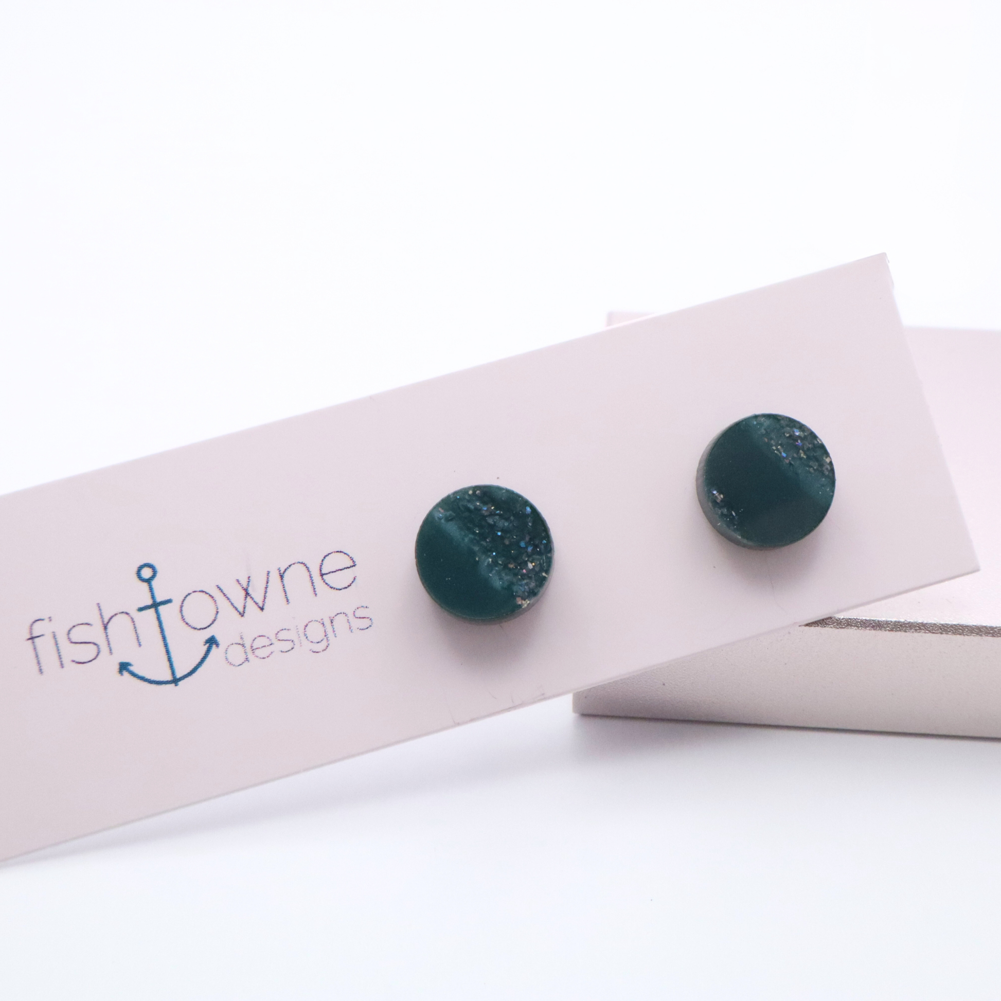 Teal earrings on a white card with Fish Towne Designs branding.
