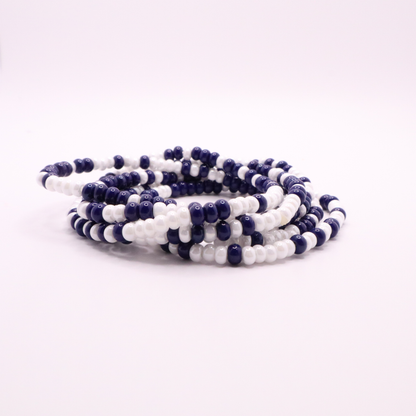 Set of six navy blue and white seed bead stretch bracelets featuring random navy blue and white seed beads on a white background