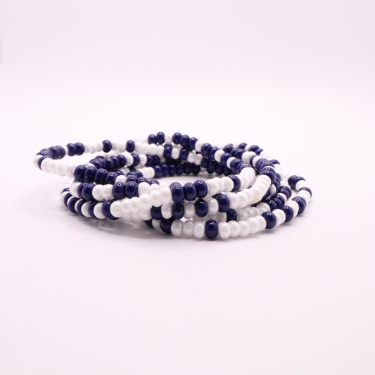 Set of six navy blue and white seed bead stretch bracelets featuring random navy blue and white seed beads on a white background