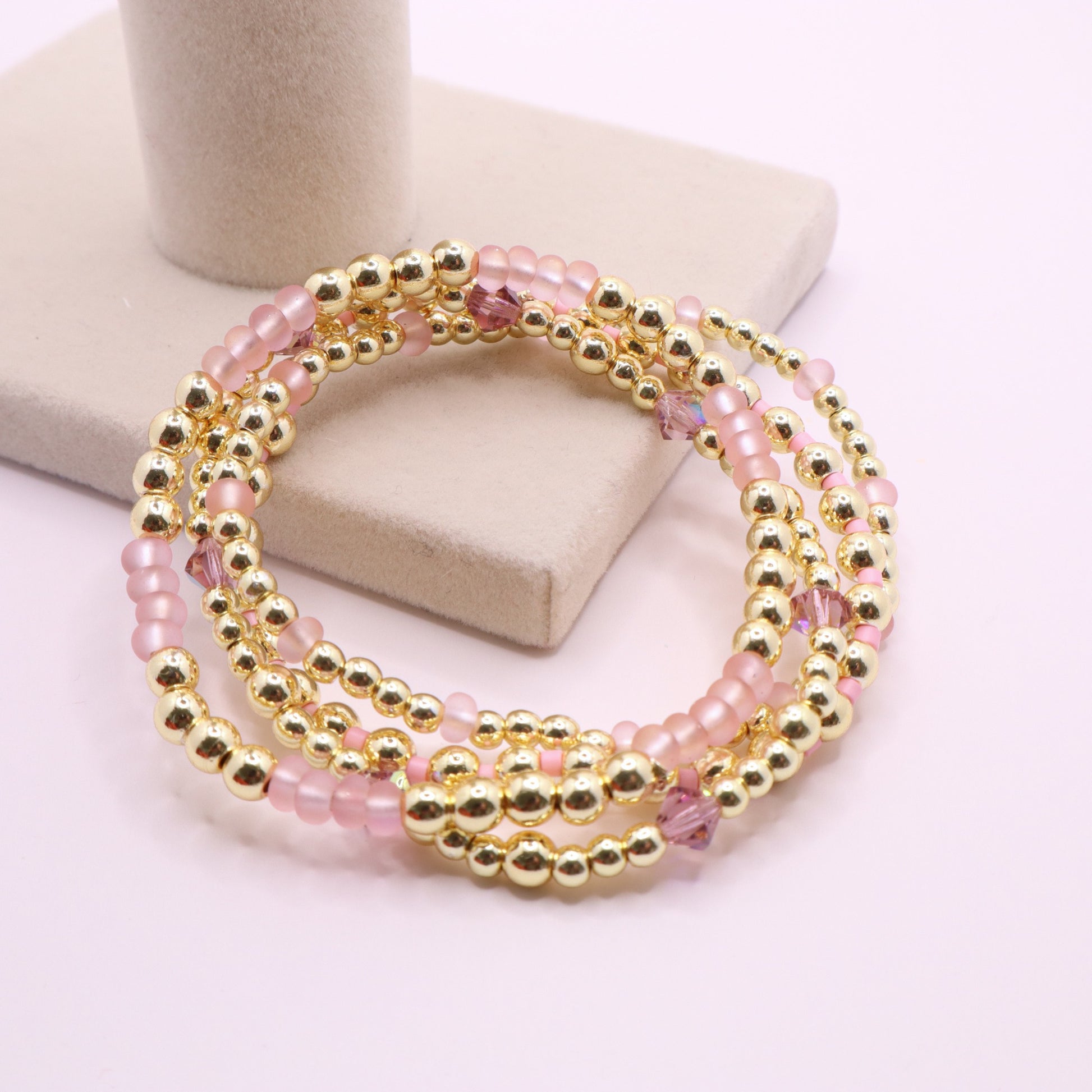 Elegant pink and gold bracelet stack designed for layering and everyday wear.