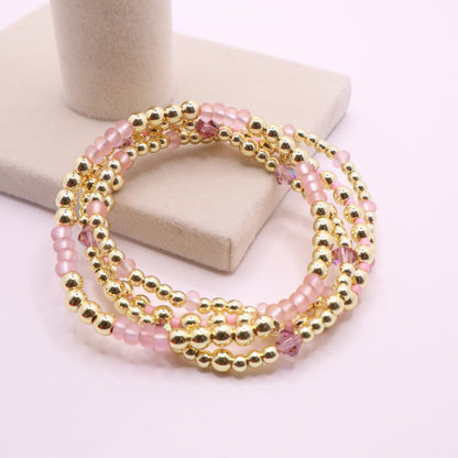 Elegant pink and gold bracelet stack designed for layering and everyday wear.