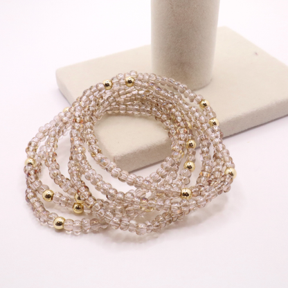 set of six neutral gold tone seed bead bracelets featuring high quality neutral seed beads and golden hematite accent beads.  The stack is displayed on a white background.