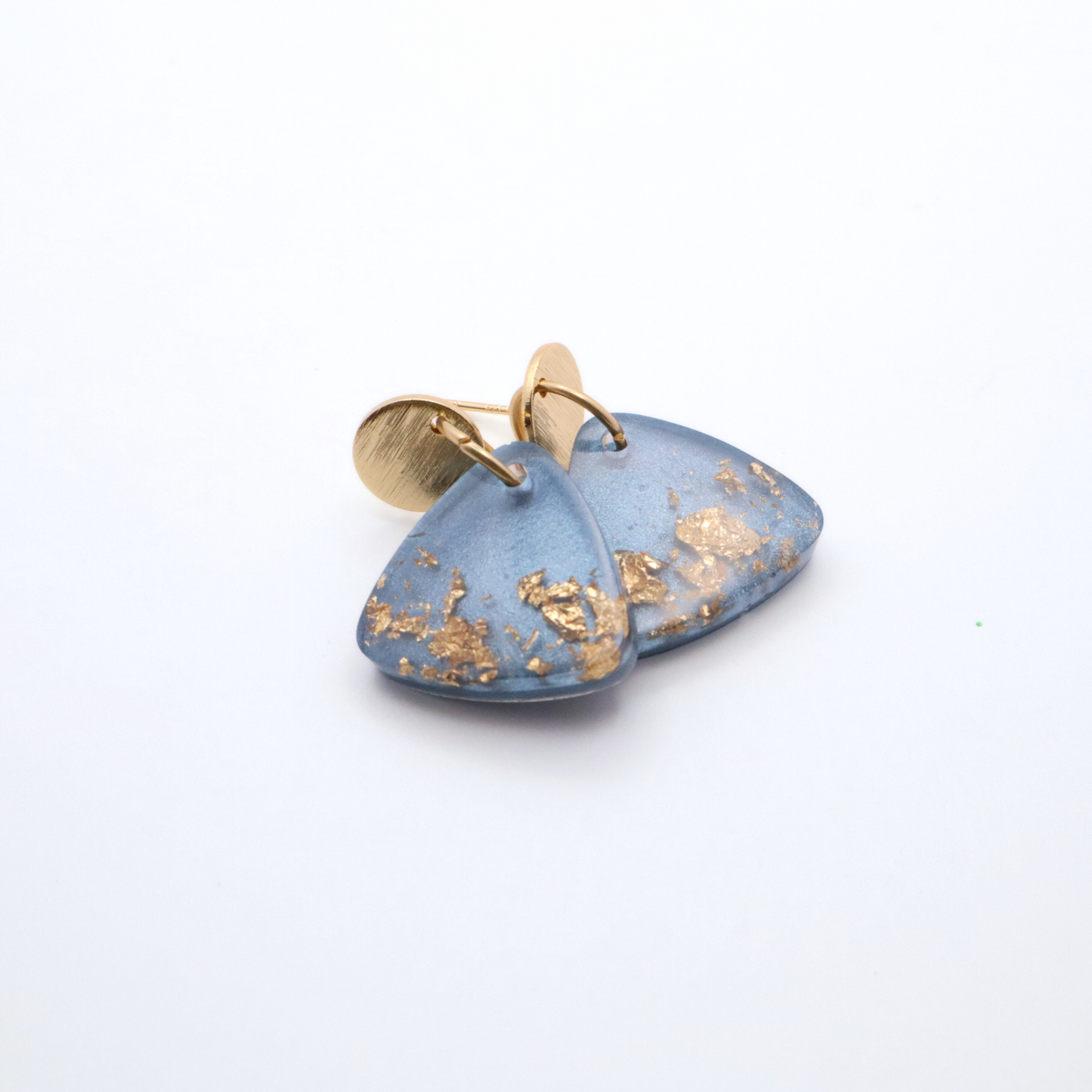 Blue earrings with gold accents on a white background