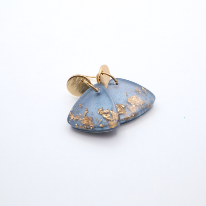 Blue earrings with gold accents on a white background