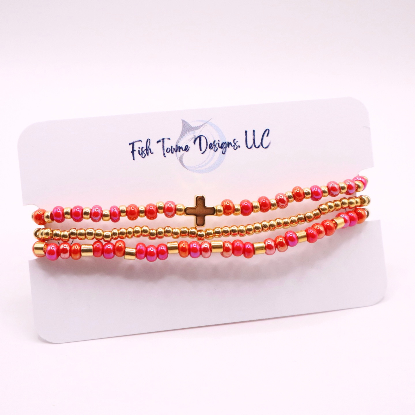 Set of pink and gold beaded bracelets on a Fish Towne Designs card.