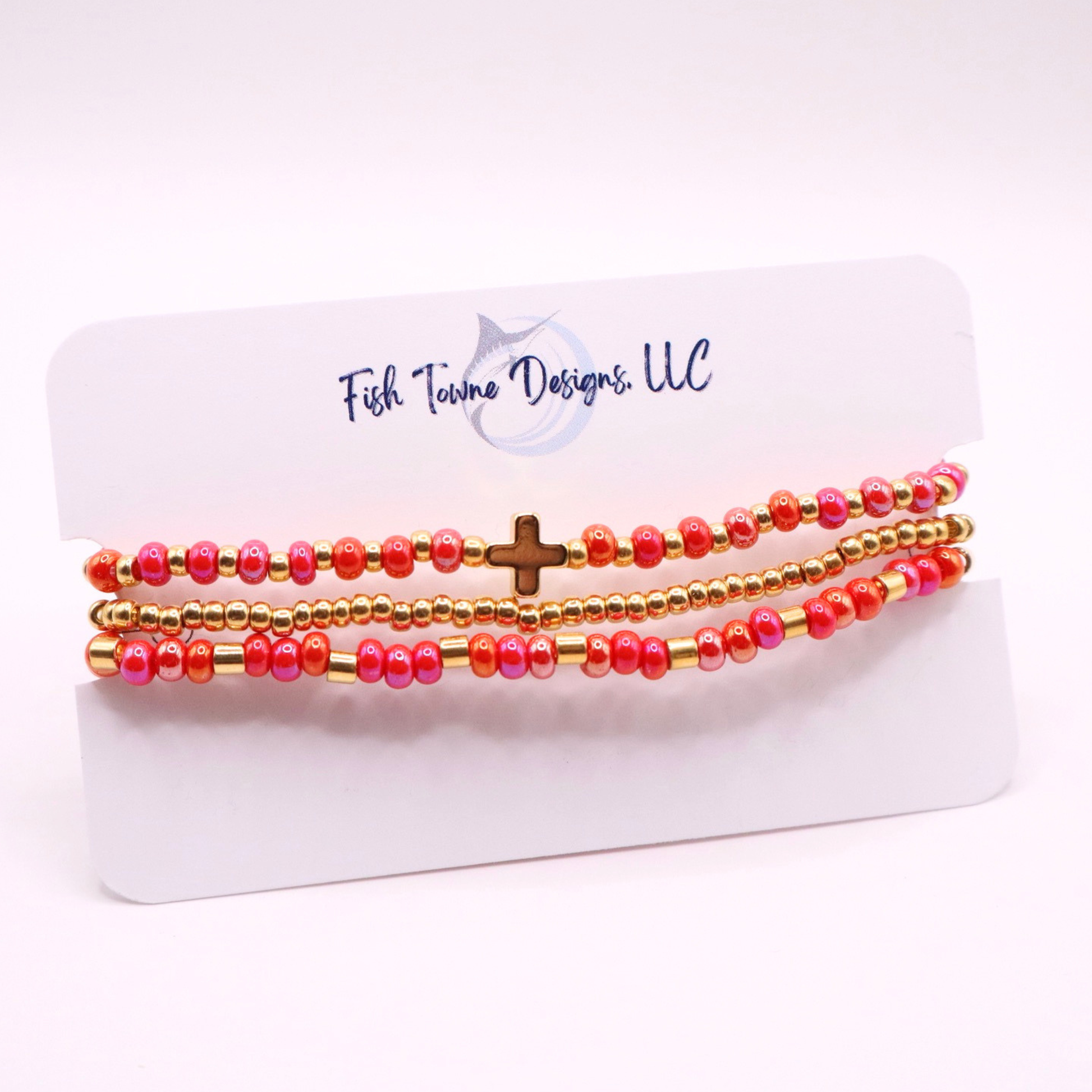 Set of pink and gold beaded bracelets on a Fish Towne Designs card.