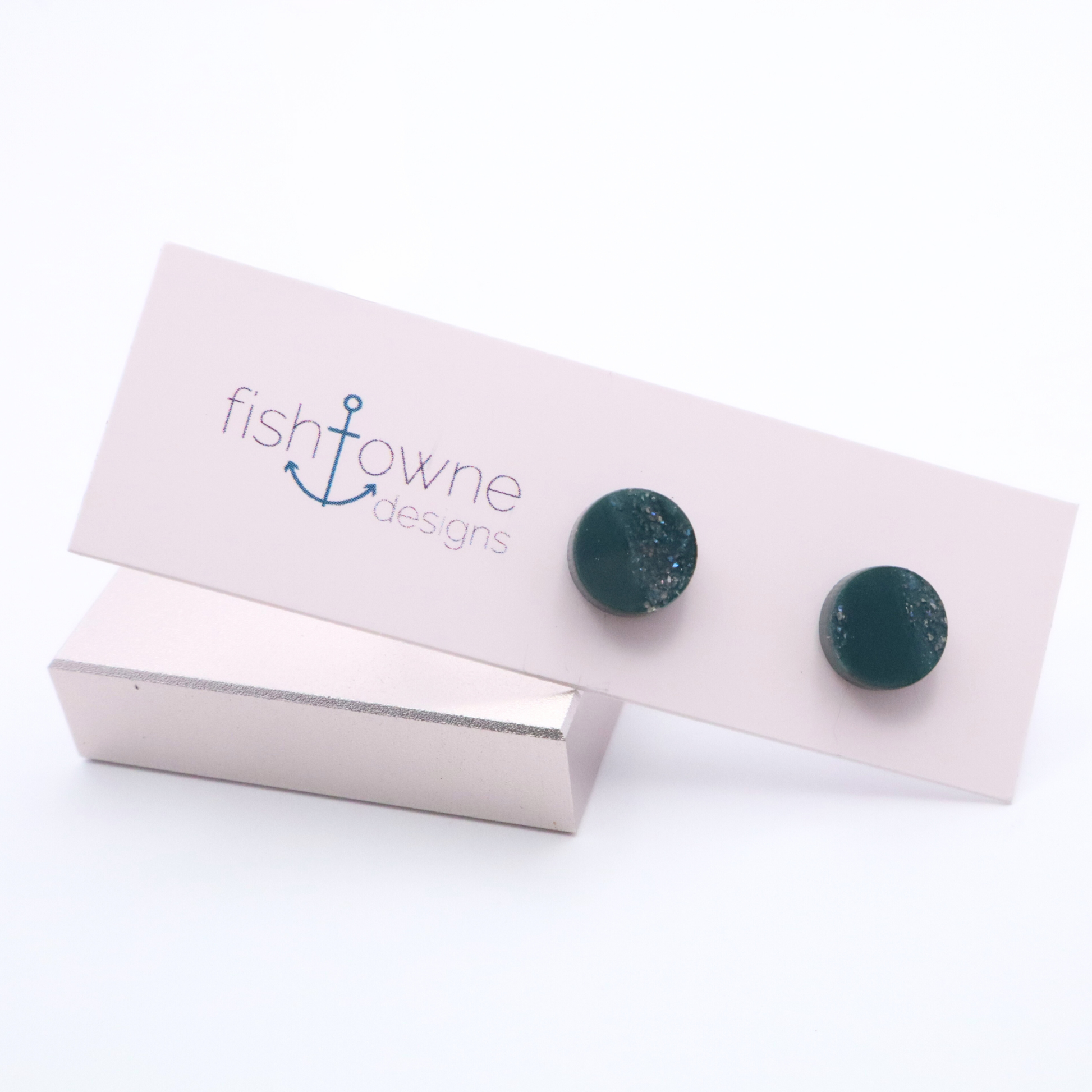 Teal stud earrings on a Fish Towne Designs branded card with a white background