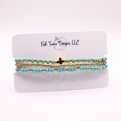 Set of turquoise and gold beaded bracelets on a white card with 'Fish Towne Designs, LLC' branding.