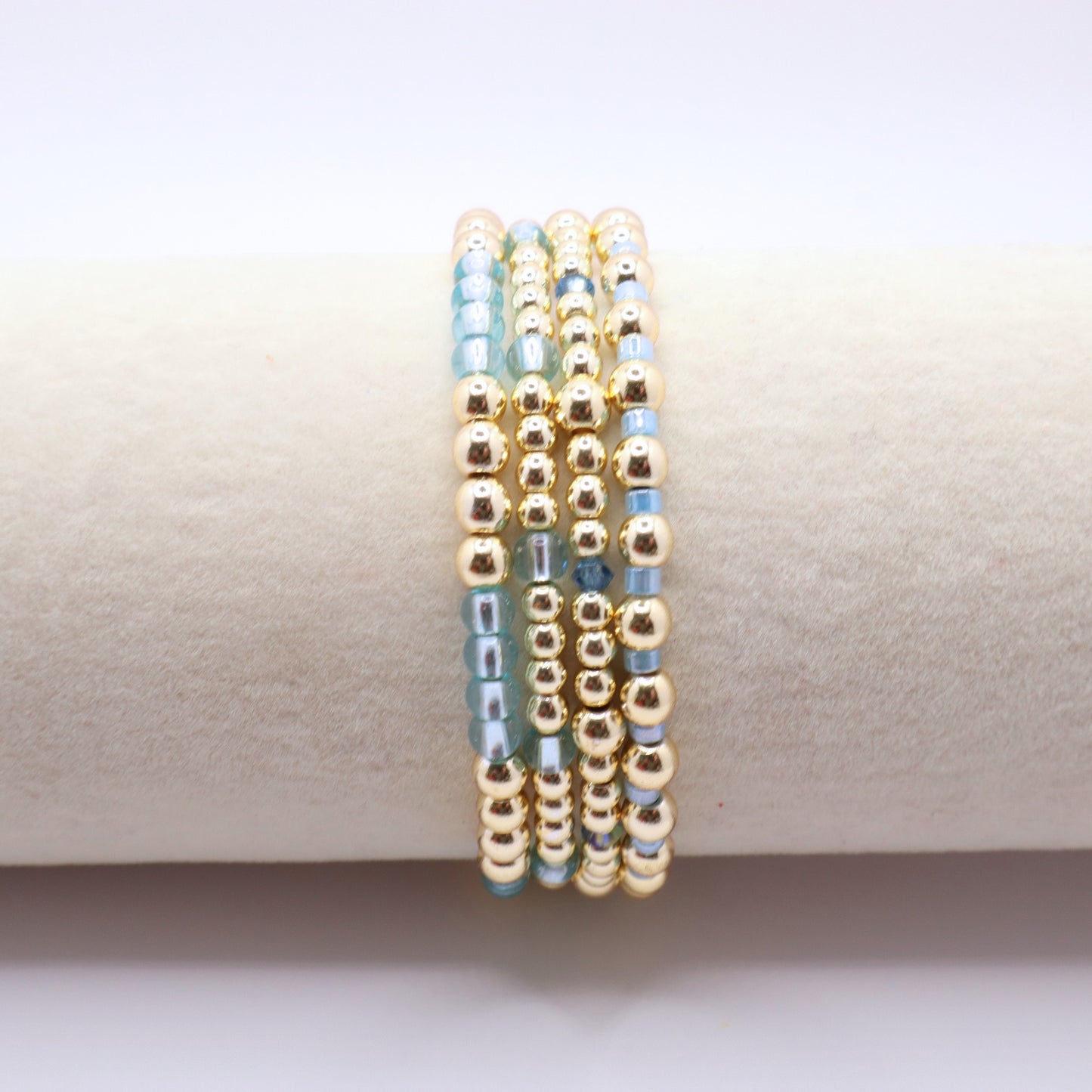 Handmade beaded bracelet set with coordinating blue glass beads and gold-tone details.