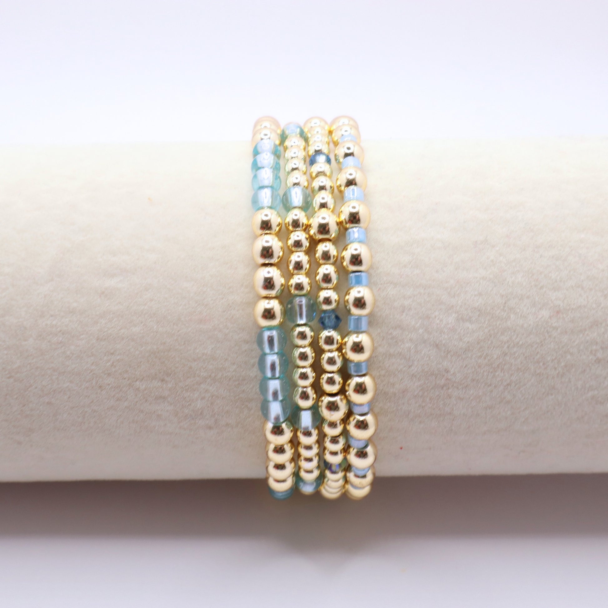 Handmade beaded bracelet set with coordinating blue glass beads and gold-tone details.