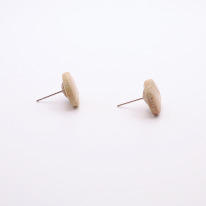 Side profile of shell stud earrings showing thickness and stainless steel posts