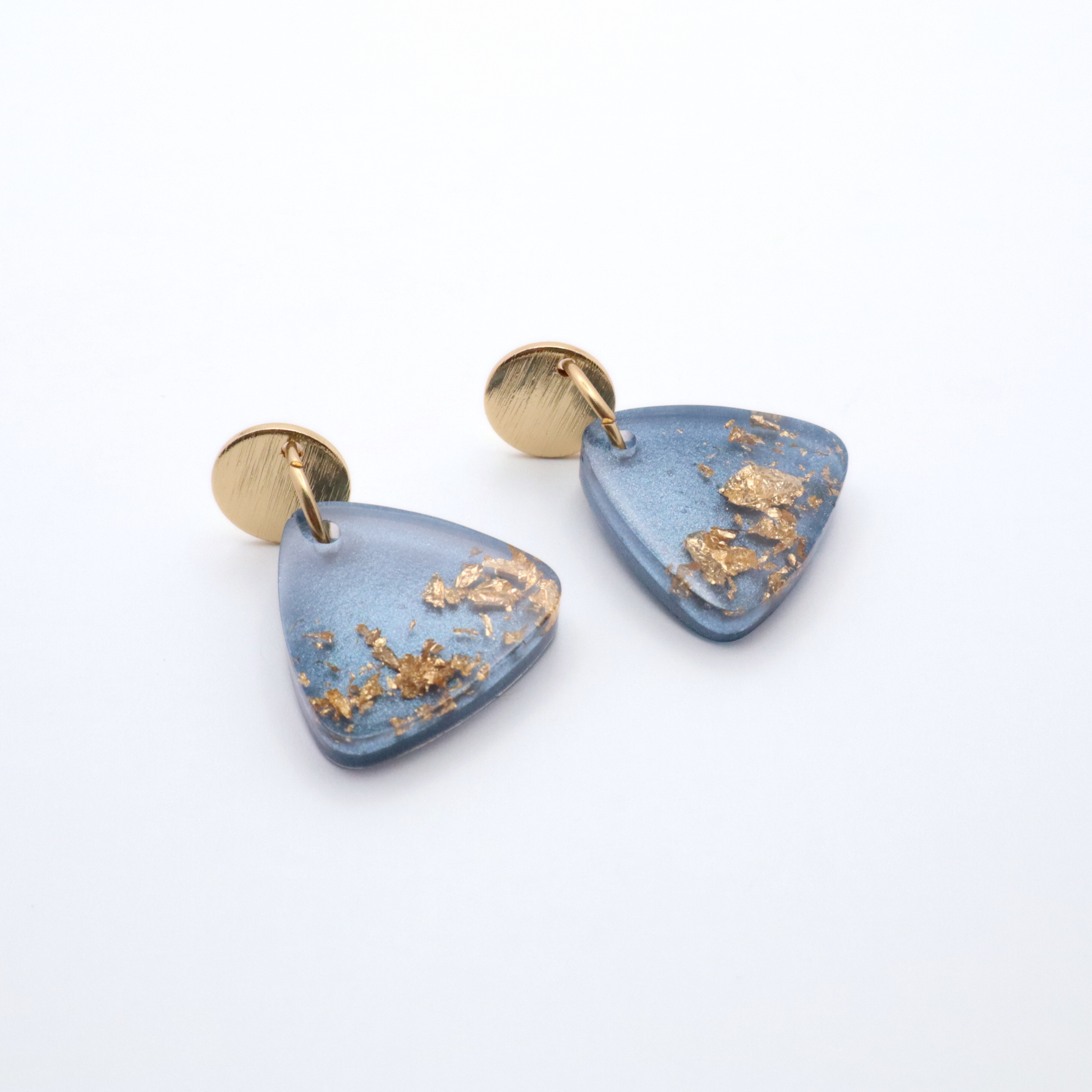 Blue triangular earrings with gold accents on a white background