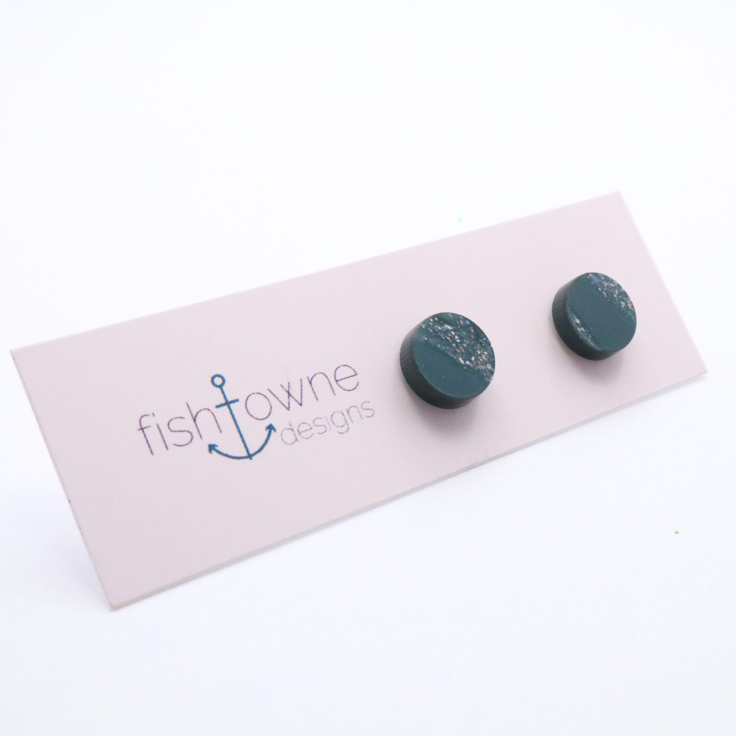 Teal earrings on a Fish Towne Designs card against a white background