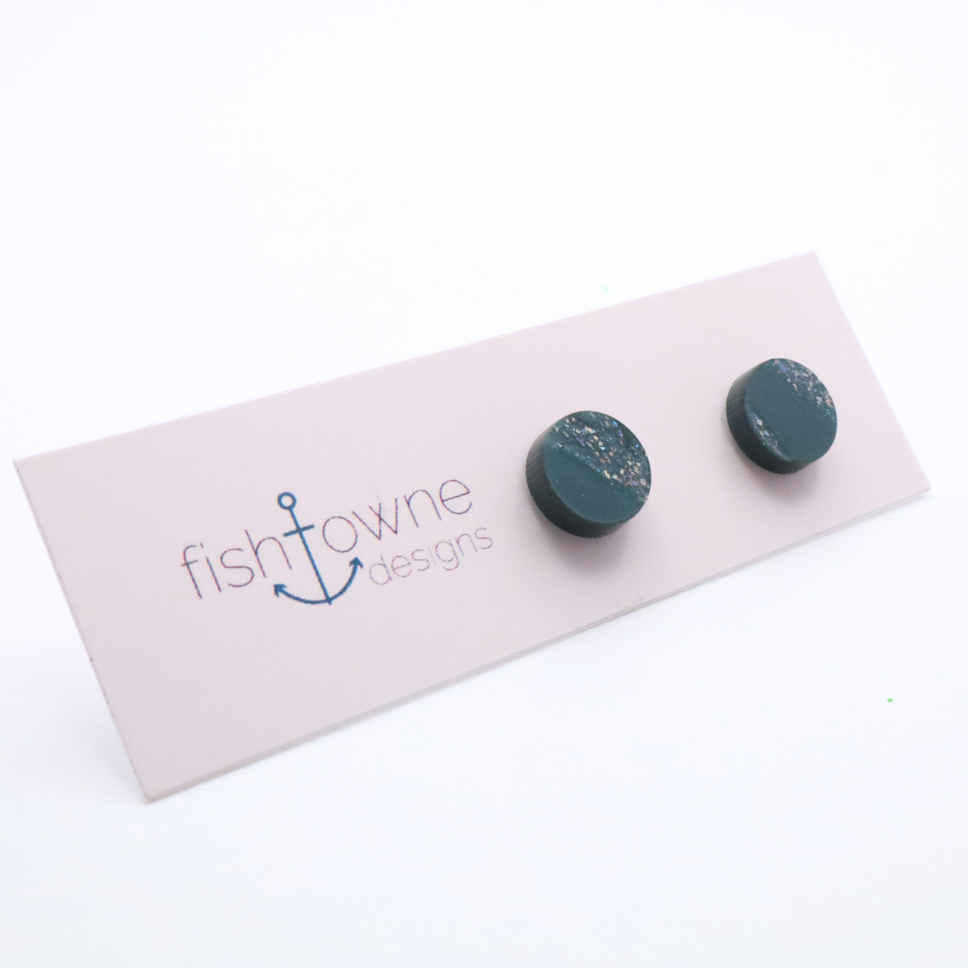 Teal earrings on a Fish Towne Designs card against a white background
