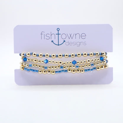 Gold and periwinkle bracelet stack designed for layering and everyday wear.
