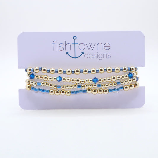 Gold and periwinkle bracelet stack designed for layering and everyday wear.