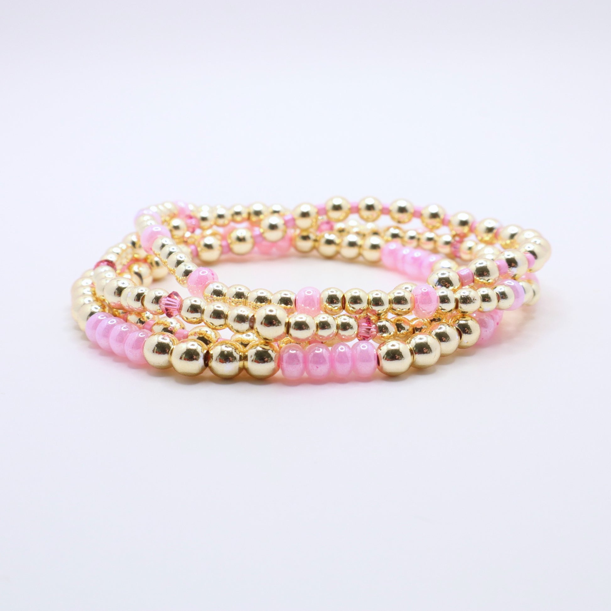 Stretch bracelet stack in pink and gold tones designed for layering and everyday wear.