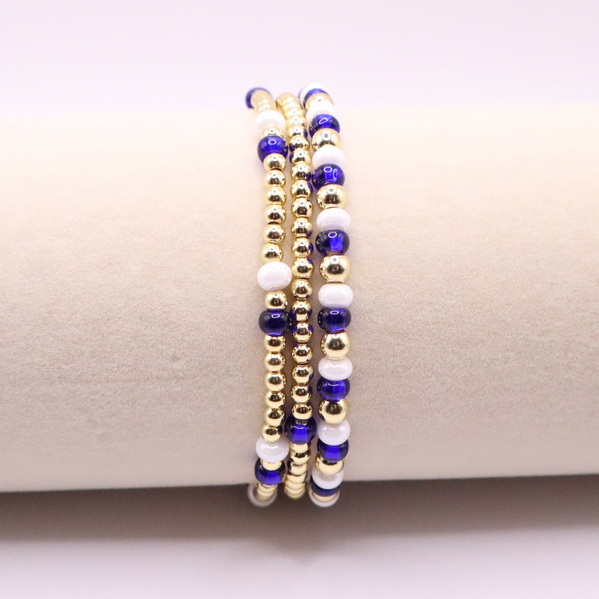 Three beaded bracelets on a white surface