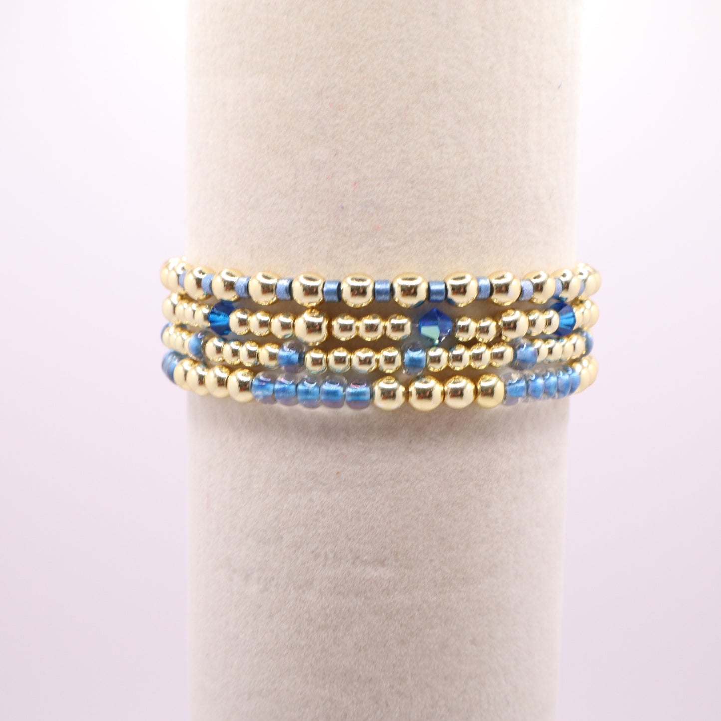 Four handmade stretch bracelets featuring soft blue glass beads and crystals.