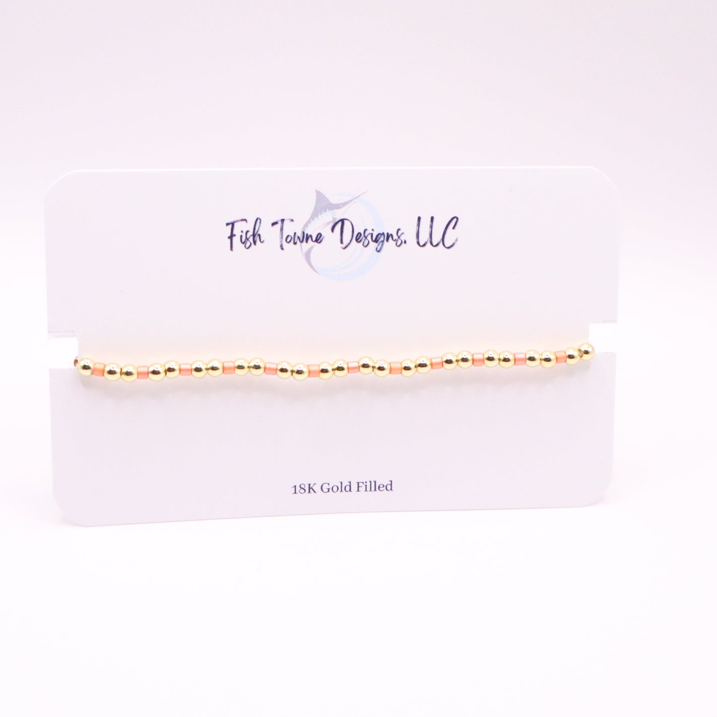 Gold and coral bracelet on a Fish Towne Designs, LLC branded card with '10K Gold Filled' text.