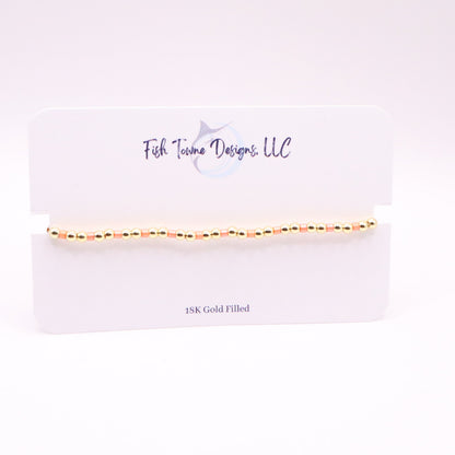 Gold and coral bracelet on a Fish Towne Designs, LLC branded card with '10K Gold Filled' text.