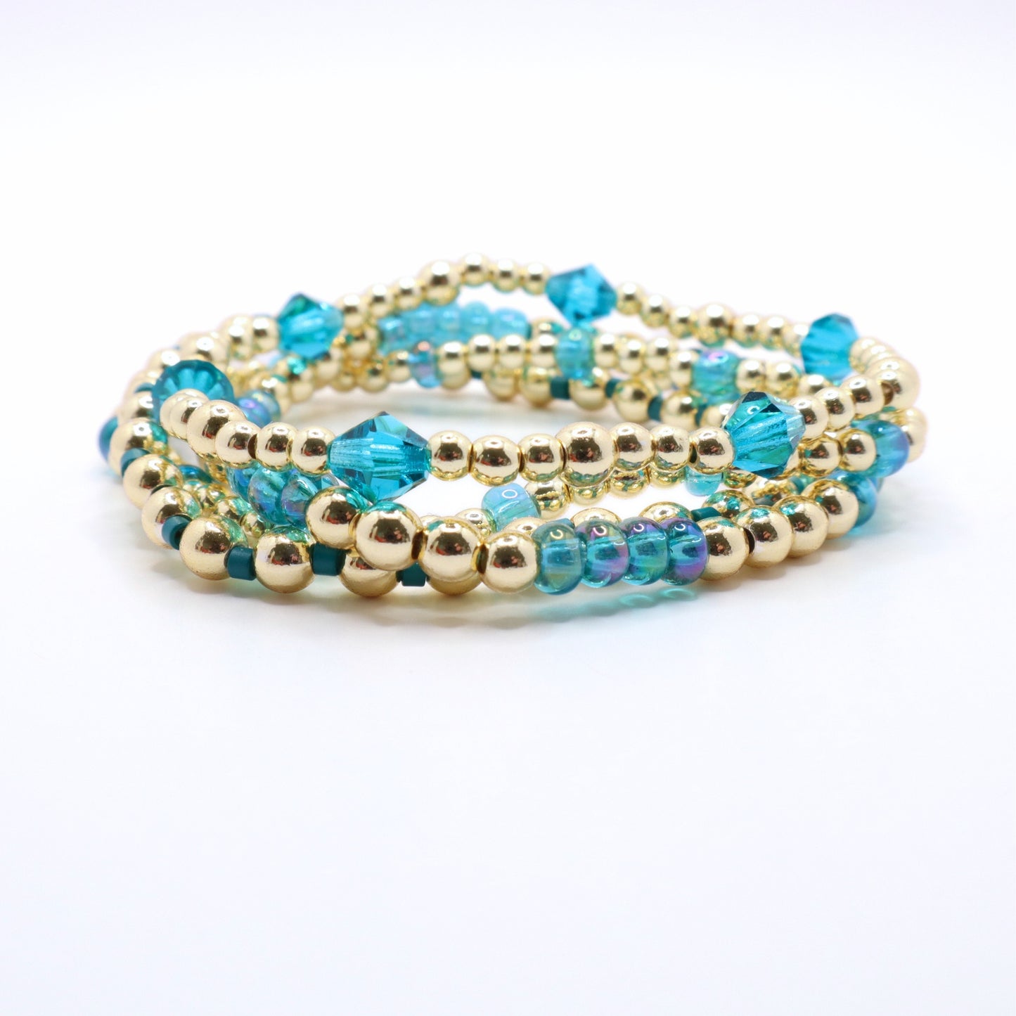 Elegant periwinkle bracelet stack with sparkling blue crystal accents.
