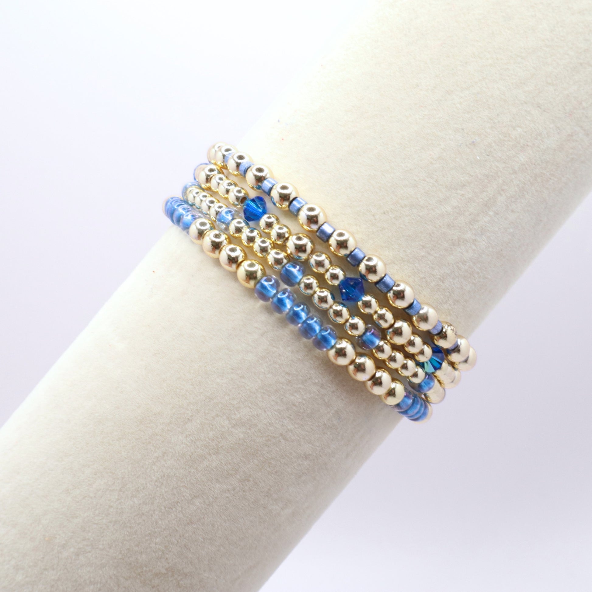 Gold hematite and blue crystal bracelet set with four coordinating stretch bracelets.