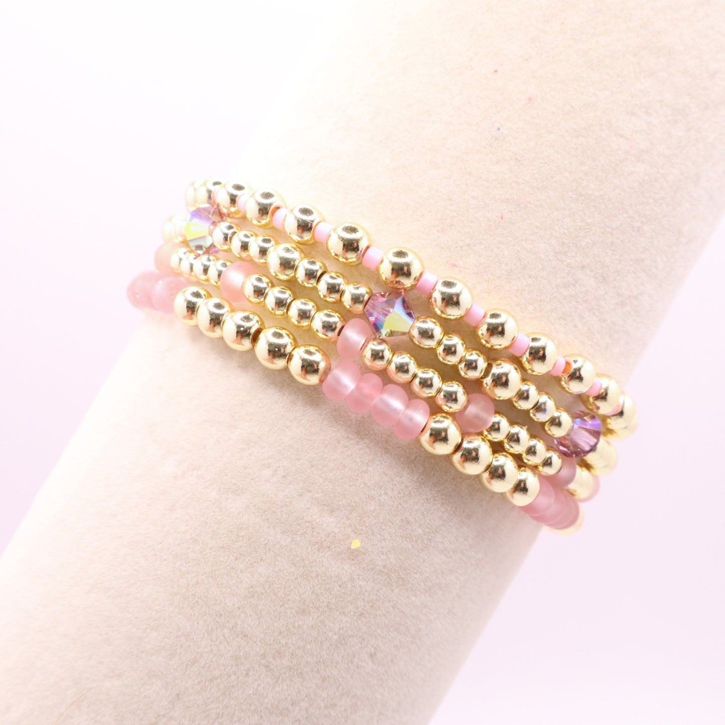Handmade pink bracelet set featuring gold-tone hematite beads and faceted crystals.