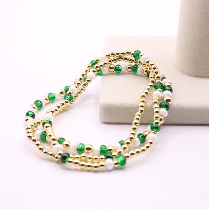 Green beaded necklace on a white background