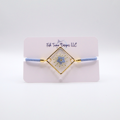 Blue forget-me-not flower resin bracelet with gold frame and light blue adjustable cord dainty handmade jewelry
