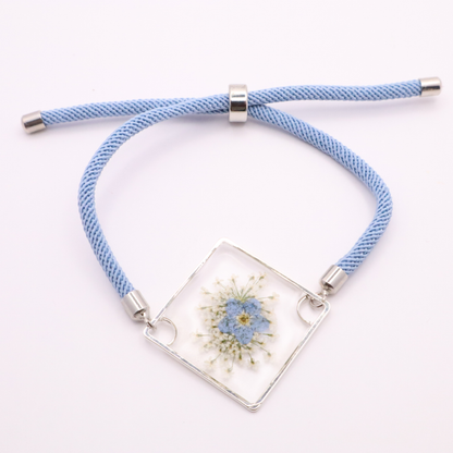 Blue forget-me-not flower resin bracelet with silver frame and light blue adjustable cord botanical handmade jewelry