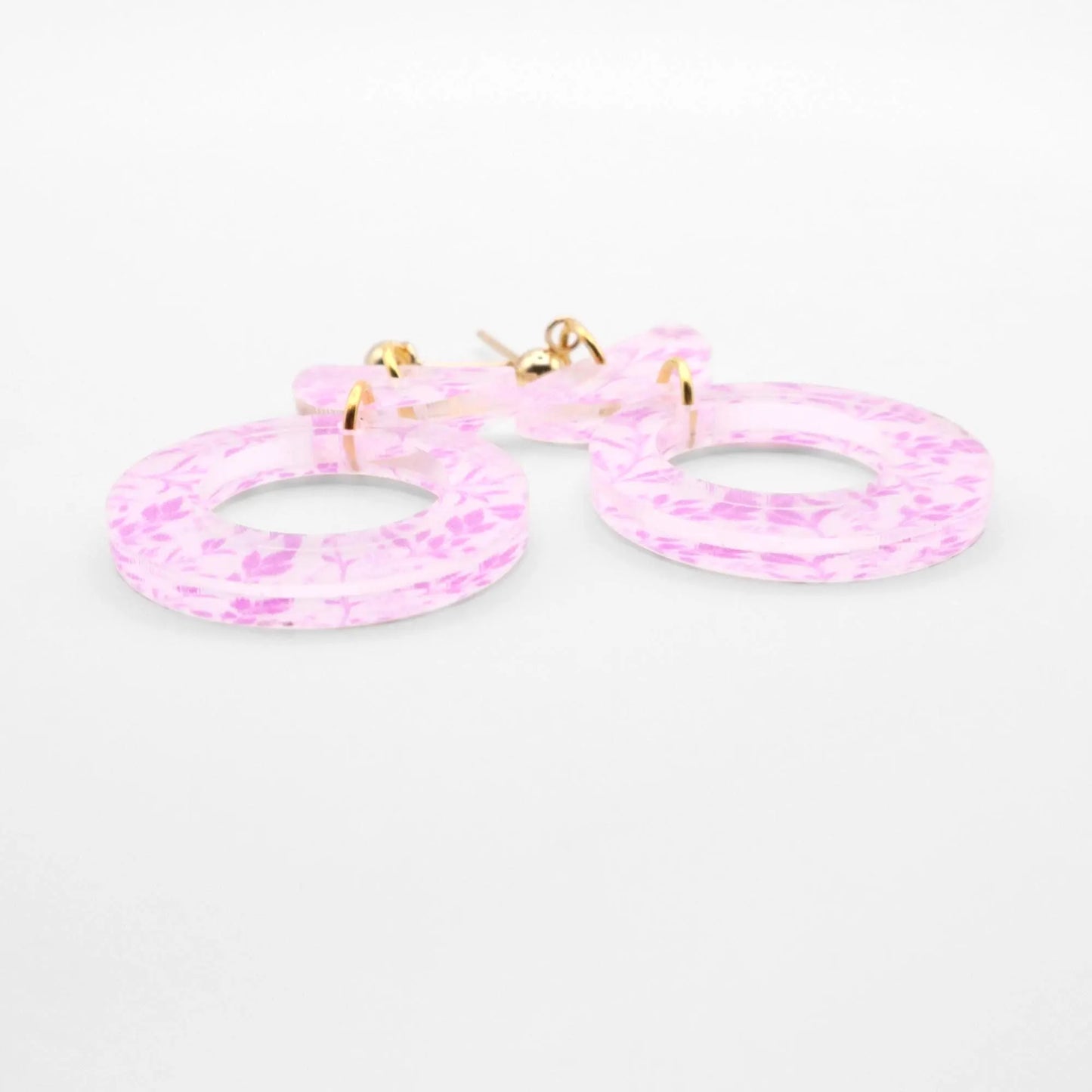 Pink hoop earrings on a white background