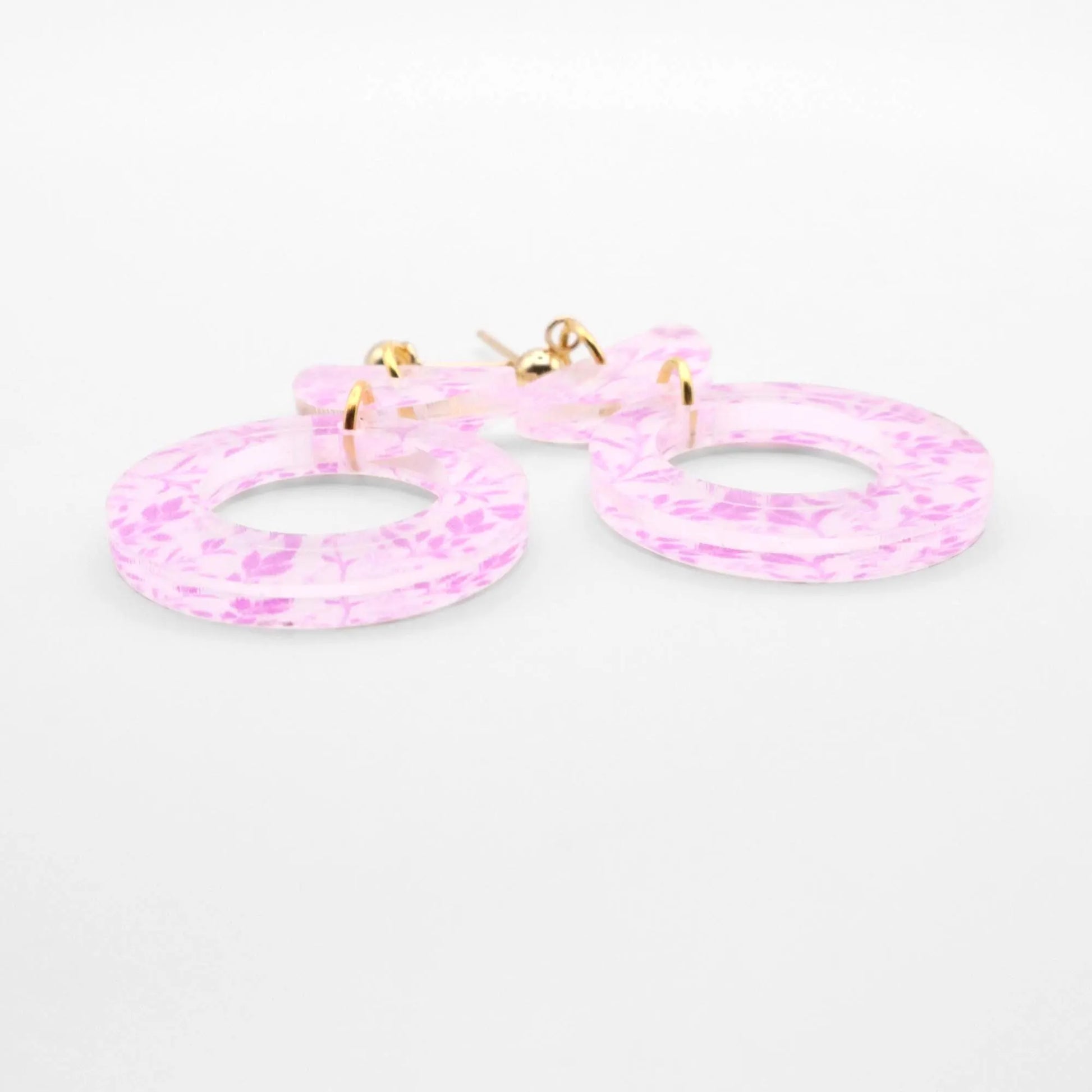 Pink hoop earrings on a white background
