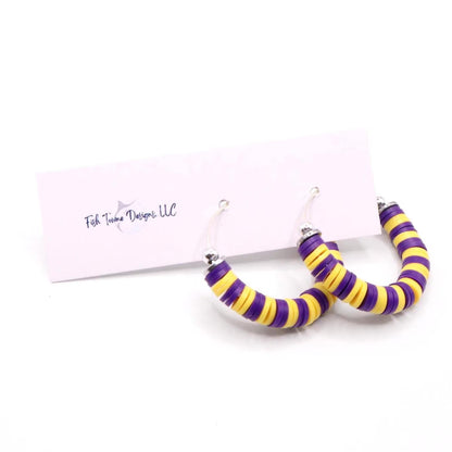 Purple and gold heishi bead hoop earrings with gold accents displayed on a branded card against a white background