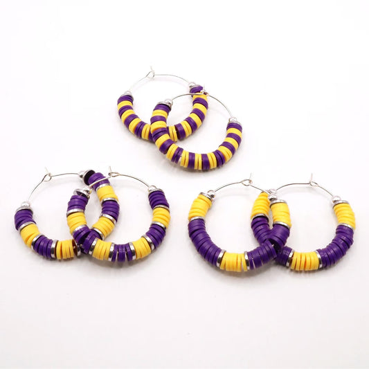 Set of three purple and gold heishi bead hoop earring styles arranged on a white background, showcasing size and pattern variations