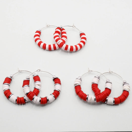 Set of three red and white heishi bead hoop earring styles arranged on a white background, showcasing size and pattern variations