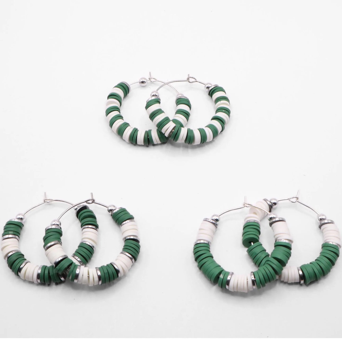 Set of three green and white heishi bead hoop earring styles arranged on a white background, showcasing size and pattern variations