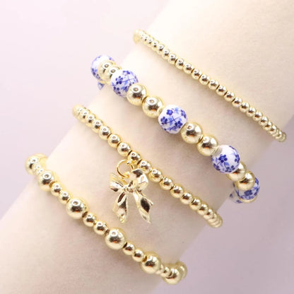 Gold and Chinoiserie Beaded Bracelet Stack with Bow Charm | Set of 4 Stretch Bracelets
