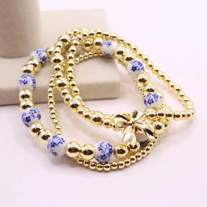 Gold and Chinoiserie Beaded Bracelet Stack with Bow Charm | Set of 4 Stretch Bracelets