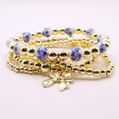 Gold and Chinoiserie Beaded Bracelet Stack with Bow Charm | Set of 4 Stretch Bracelets