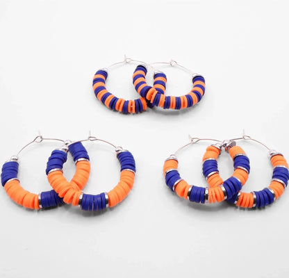 Set of three blue and orange heishi bead hoop earring styles arranged on a white background, showcasing size and pattern variations