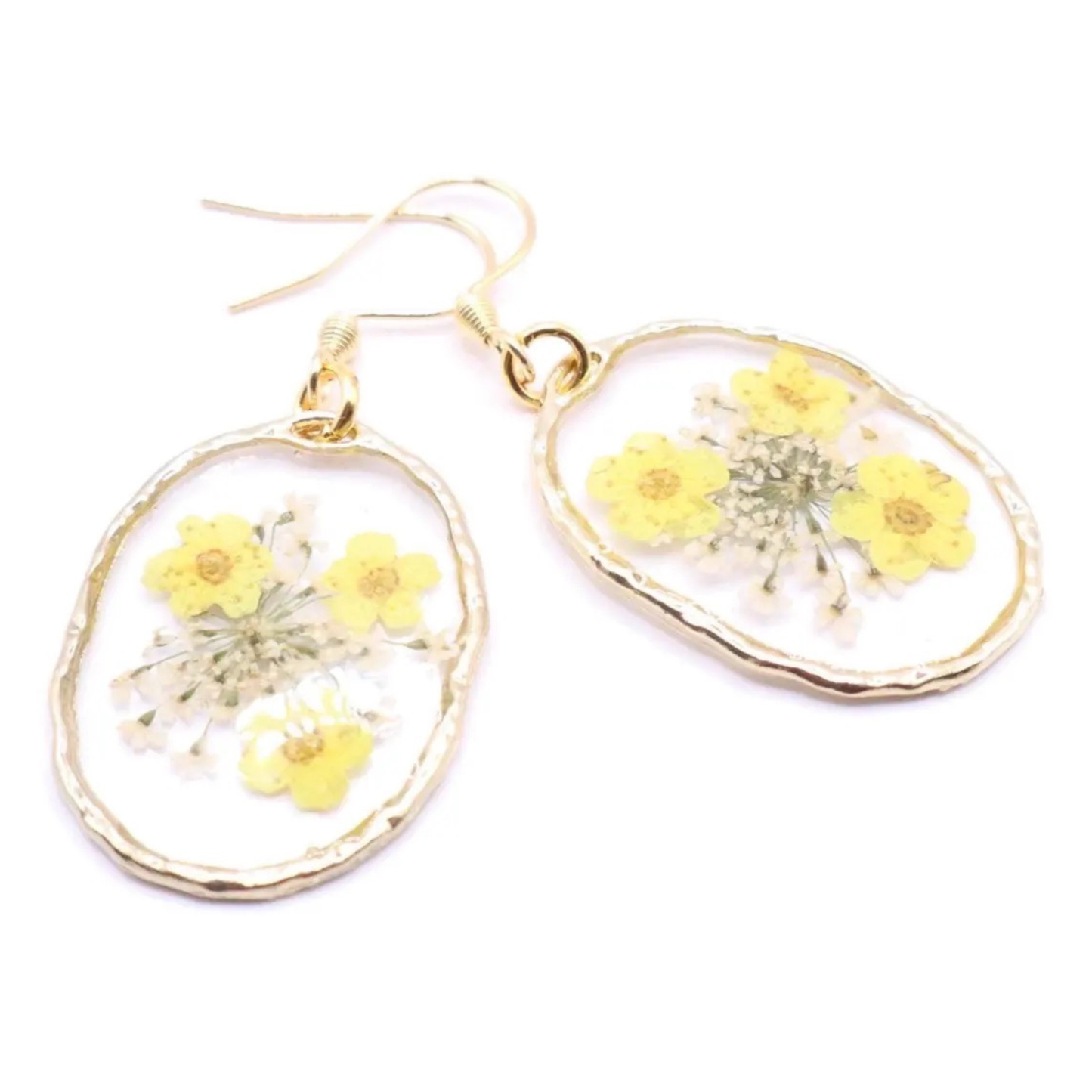 Handmade resin earrings featuring pressed yellow flowers and delicate white florals in clear oval setting with gold edge and hook ear wires